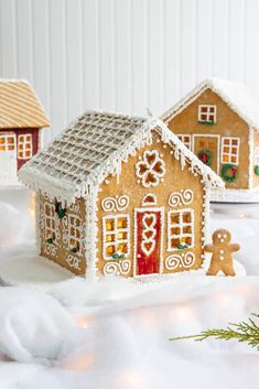 three gingerbread houses are sitting in the snow