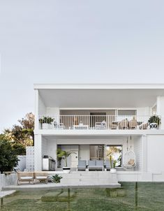 a large white house sitting on top of a lush green field