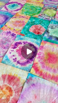 a colorful tie - dyed blanket with a video playing