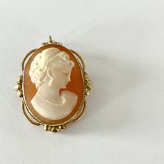 This gorgeous 1950s Admark Cameo Brooch is in spectacular condition. It has a loop clasp so that it can also be worn as a pendant on a necklace.  Measures 1 1/4 inch X 1 inch Marked 14k / ADMARK Please contact me with any questions. Anniversary Oval Brooches, Oval Brooches For Formal Occasions, Mid-century Yellow Gold Brooch For Gifts, Mid-century Yellow Gold Brooch Jewelry, Classic Oval Brooches, Mid-century Yellow Gold Brooch, Heirloom Oval Brooch Jewelry, Formal Cameo Pendant Brooch, Elegant Medallion Brooch For Collectors