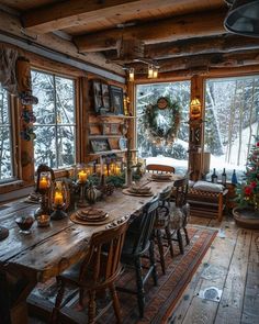 a dining room table with chairs and candles on it in front of a large window