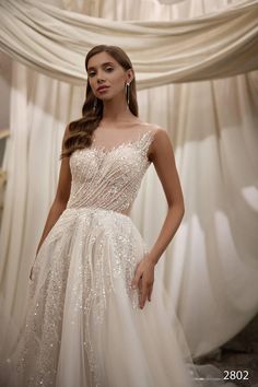 a woman in a wedding dress posing for the camera