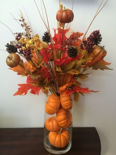 a vase filled with lots of different types of autumn decorations