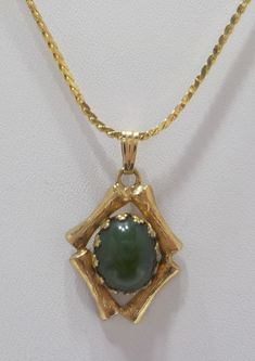 "Vintage jade pendant necklace. 16\" gold tone chain with spring fastener. Gold tone pendant is 3/4\" x 1/2\". Prong set oval jade cabochon in the center. Excellent condition." Oval Jade Gold Necklace, Jade Pendant, Prong Setting, Jade, Gold Tones, Pendant Necklace, Chain, Pendant, Gold