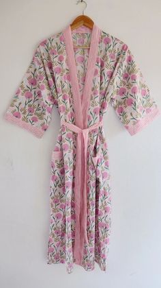 Cotton kimono robes which are perfect for lounging around the home or spa. Use our Hand Block Print robe as a cover up on the beach or after a dip in the pool. Add a luxe, boho feel to your bridal shower. Versatile, soft and luxurious, our 100% cotton kimono robes are printed with azo-free dyes. The printed robe features 3/4th sleeves, a waist tie and two front pocket. Material :- 100% Cotton Fabric Print :- Hand Block Print Size - One size will fit sizes S to XL Length - 48 inches (125 Centimeter), mid calf Note: Girl wear the kimono has height 5.3' feet and more Measurements Approx : *Length: 50" Inches *Bust Around Size: 48" Inches *Shoulder: 8" Inches *Sleeve Length: 14" Inches *2 Side Pockets For best results hand wash and line dry when possible. Machine wash cold, tumble dry low and Pink Kimono For Home Use In Spring, Pink Kimono For Home During Spring, Pink Spring Kimono For Home, White Spring Kimono For Relaxation, Summer Pink Sleepwear With Kimono Sleeves, Pink Floral Print Robe For Home, Pink Floral Print Home Robe, White Summer Kimono For Relaxation, Summer White Kimono For Relaxation