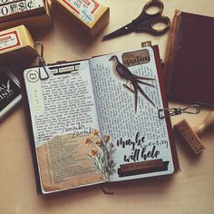 an open book sitting on top of a table next to some scissors and other items