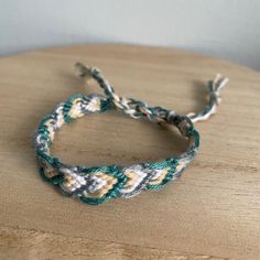 A Handmade Bracelet Or Anklet Woven With Shades Of Cream, Green, And Gray Colors. A Friendship Or Statement Bracelet Perfect For This Summer! Approx. 9 Inches/ 30 Centimeters Long. 10 Woven Bracelets For $25. Neutral Colored Friendship Bracelets, Macremae Bracelet, Macrama Bracelets, Shades Of Cream, Cool Friendship Bracelets, David Yurman Bracelet, Faux Pearl Bracelet, Green And Gray, Woven Bracelet