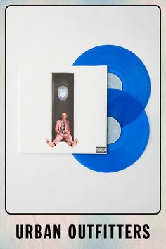 two blue records sitting next to each other on a white surface with the words urban outfitters