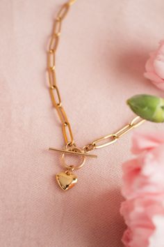 This heart necklace is secured with a toggle clasp, adding a touch of elegance to its chunky design. This statement piece can elevate any outfit, offering a mix of edgy and romantic vibes.   DETAILS * Pendant is Thick Gold Plated and measures 9mm x 9mm * Chain is Stainless Steel Paperclip * Toggle is Gold Filled If you are not wearing your jewelry, whether gold-filled or sterling silver or plated, it is best to store it in a cool, dry place such as your gift box that is included in your order. GIFTS All E+O orders are lovingly packaged in a jewelry box ready for gifting. In the box you will find a care card and cleaning cloth to keep your E+O pieces looking shiny and new. If this is a gift we can ship directly to the recipient and include a personalized note. Not to worry, we never include Heart Toggle Necklace, Romantic Vibes, Paperclip Necklace, Toggle Necklace, Necklace Chunky, Necklace Layering, Necklace Statement, Care Card, Best Friend Gift