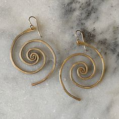 In these bronze or sterling silver plated earrings, the beauty of the universe intertwines with the artistry of the human hand. A crowd favorite, classic Lochlin Smith design. The larger sibling to our Spiral Galaxy Earrings. Length includes earwires. Earwires are 14/20 gold filled or sterling silver depending on color. Nickel-free Bronze Artsy Earrings, Nickel Free Jewelry With A Modern Twist, Artistic Nickel-free Metal Hoop Earrings, Artistic Metal Hoop Earrings Nickel Free, Spiral Earrings With A Modern Twist, Artsy Brass Dangle Jewelry, Modern Twist Spiral Wrap Earrings As Gift, Nickel-free Jewelry With A Modern Twist For Gifts, Modern Twist Nickel-free Jewelry Gift