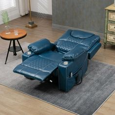 a blue recliner sitting on top of a rug in a living room next to a table