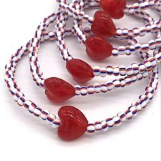 This set of beaded stretch bracelets are handmade in the U.S.A. The red white and blue striped glass seed beads are size 6/0 and strung on a one size fits all stretchy cord next to a single featured silver foil lined glass red heart bead. The lot comes just as pictured in a group of 10 bracelets. As they are each handmade, very slight variations will occur, which increases the value of each piece. Buying handmade and wholesale from the U.S.A. means you get the most affordable and the fastest shipping. This lot ships free with USPS first class. ThisBeadCo. is well known for its minimalist bracelet designs. For ThisBeadCo. products, the highest quality beads are always strung by hand in the United States of America. These discount wholesale lots are perfect as party favors or for resale at c Seed Bead Ideas, Bracelets Design, Metal Cross, Minimalist Bracelet, Bead Ideas, Red Hearts, Glass Heart, Bracelet Ideas, Glass Seed Beads