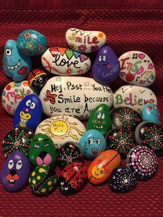 colorful painted rocks with the words smile and some sayings written on them in different languages