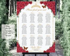 a red and gold wedding seating sign with roses on it in front of some trees