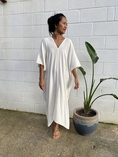 ITEM DETAIL * Bust / Waist / Hips up to 68 in. * Arms open up to 22 in. * Length 42 in. * V-Neck * Side slits * No pocket * Slipover style * All above measurement are flat FABRIC * 100% Double Gauze Cotton FIT * One size fit most up to size US 4 XL * Hangs loose and away from the body * Length can be versatile as a knee length, mid calf length, ankle length and floor length depending on your style MODEL * Height 5 ft. 4 in. / 163 cm. * With or without 4 in. High Heels CARE * Hand washing recomme Relaxed Fit V-neck Beach Dress For Vacation, Relaxed Fit V-neck Maxi Dress For Vacation, White V-neck Kaftan For Spring, Bohemian White V-neck Cover-up, White V-neck Maxi Dress For Loungewear, Summer V-neck Relaxed Fit Kaftan, White V-neck Cover-up For Loungewear, White V-neck Loungewear Cover-up, Beige V-neck Beach Dress Cover-up