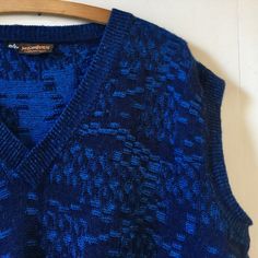 "Gorgeous vintage 80s Yves Saint Laurent sleeveless sweater tank. In all things blue. It's like a petrol blue running through it which gives it such a depth of colour. Made from wool and acrylic condition is used but very good. No snags or pulls found. It's a real gem. Size wise it states L and measures a 50\" chest. We do accept returns but only if the item has been grossly misdescribed and not because you have a change of mind or you have not checked measurements carefully we're afraid. Any questions please ask. Many thanks" Blue Sleeveless Sweater Vest For Winter, Blue Knit Sleeveless Vest, Blue V-neck Tank Top For Fall, Blue Sleeveless Casual Sweater, Blue Sleeveless Knit Sweater, Blue Sleeveless Winter Top, Blue Vest-style Sweater For Fall, Blue Sleeveless Top For Winter, Blue Vest Sweater For Fall