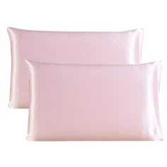 two light pink pillows sitting next to each other