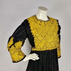 Stunning handmade Afghan Kuchi dress, richly decorated with traditional golden embroidery. The dress is made of heavy velvet, which is soft to the skin and a pleasure to wear. This dress is about 30 years old and is handmade with lots of love, patience and skill. Although the dress is in excellent condition, signs of wear, a (moth) hole, a small damage or/and a stain are likely. Despite its high age, the dress is in excellent condition. This dress is having no pockets. This dress dress can be ad Gold Embroidered Dresses For Traditional Ceremonies And Festivals, Traditional Dresses With Gold Embroidery For Ceremonies, Traditional Fitted Dress With Gold Embroidery, Velvet Traditional Wear With Zari Work For Ceremonies, Ceremonial Dresses With Gold Embroidery For Festivals, Traditional Gold Dress With Floral Embroidery, Gold Dress With Intricate Embroidery For Traditional Ceremonies, Gold Dresses For Traditional Festivals, Gold Dresses For Traditional Ceremonies And Festivals