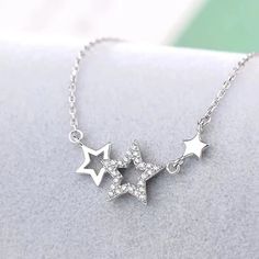 Make a stellar impression with our Shooting Stars Necklace! This fashionable piece features a magnificent star pattern crafted with durable zinc alloy metal. Show off your star power with this stunning accessory! DETAILSPattern Type: StarMaterial: MetalMetals Type: Zinc alloy Elegant Y2k, Shooting Star Necklace, Pentagram Design, Stars Necklace, Butterfly Fashion, Pretty Jewelry Necklaces, Star Necklace Silver, Necklace Elegant, Jewelry Accessories Ideas