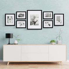 a living room scene with focus on the sideboard and pictures hanging on the wall