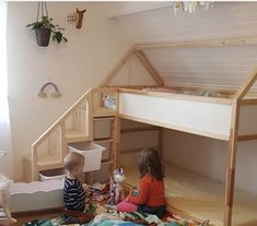 two children sitting on the floor in front of bunk beds with stuffed animals and toys