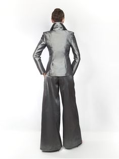 Our EXCLUSIVE limited edition. Dark silver semi stretch taffeta ladies pantsuit. Made exclusively to order in house. Introducing my latest obsession: a made-to-measure, dark-silver pantsuit that’s perfect for summer days at the office! ☀️ This sexy and feminine silhouette features strong shoulders and a stand-up collar, making a bold statement while keeping me comfortable all day long. 💃 Plus, it’s wrinkle-free, easy to care for, and incredibly flattering! 🌟 Say goodbye to wardrobe dilemmas and hello to effortless style with this must-have piece. CARE: Dry clean only TURNOUROUND TIME: 14 - 19 business days processing + shipping via USPS. You can choose express USPS express shipping as well. Contact us if you need to hurry. +++++++++++++++++++++++ Size Guide https://mologokocouture.com/pa Elegant Silver Party Pants, Elegant Silver Pants For Evening, Fitted Satin Pantsuit For Workwear, Elegant Fitted Silver Bottoms, Silver Elegant Evening Bottoms, Metallic Fitted Pants For Formal Occasions, Silver Fitted Bottoms For Formal Occasions, Elegant Fitted Silver Pants, Elegant Fitted Metallic Bottoms