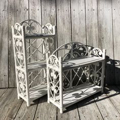 two white benches sitting on top of a wooden floor