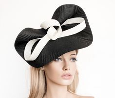 Elegant Black and White Kentucky derby hat for woman. This Black and White fascinate hat is embellished with a big bow. It is a perfect hat for weddings, Royal Ascot horse races, cocktails, derby... It is mounted on a headband. If you want, you can choose the side of the head were you like to wear the fascinator, just convo me. Any color of the fascinator can be changed to order. * PROCESSING TIME: 1 - 10 business days. * DELIVERY TIME (DHL Express): 1-4 business days to all countries Elegant Kentucky Derby Hat With Bow, Kentucky Derby Formal Mini Hat With Bow, Elegant Bow Hat For Kentucky Derby, Formal Mini Hat With Bow For Kentucky Derby, Chic Black Fascinator For Royal Ascot, Party Hat With Bow And Curved Brim, Black Hat For Spring Events, Royal Ascot Evening Top Hat, Evening Hats With Bow And Short Brim