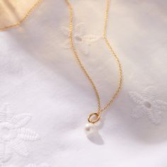 The Pearl Mini Charm Necklace embodies timeless elegance and the precious bond between mother and child. Just as a pearl grows in beauty over time, it serves as a graceful reminder of the love that strengthens with each passing moment. Wear it alone or layer it with your favorite Tiny Tags necklace for a look that’s both meaningful and chic. available in gold vermeil and sterling silver genuine pearl is 7mm hangs on diamond cut chain. View our necklace size guide here. Formal Pearl Necklaces For Mother's Day, Elegant Round Pearl Necklace For Mother's Day, Elegant Gold Pearl Necklace For Mother's Day, Elegant Pearl Drop Necklace For Mother's Day, Elegant Mother's Day Pearl Necklace With Clavicle Chain, Formal Pearl Chain Jewelry For Mother's Day, Mother's Day Pearl Charm Jewelry, Mother's Day Round Pearl Charm Jewelry, Feminine Pearl Charm Necklaces For Anniversary