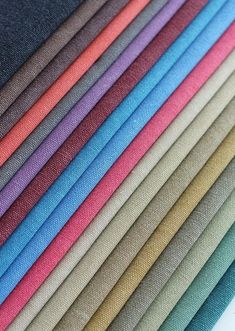 many colors of fabric are arranged in rows