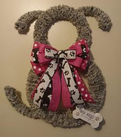 a stuffed animal with a pink bow on it's head and paws around the neck