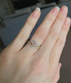 a woman's hand with a diamond ring on it