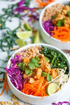 two white bowls filled with different types of food and garnished with cilantro