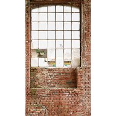 an old red brick wall and window with bars