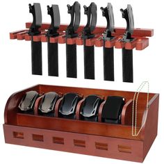 a set of six pairs of black and silver watches hanging on a wooden rack with matching leather cases