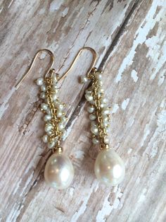 "Impressive 12 mm freshwater pearls hang from dozens of tiny seed pearls wrapped on gold fill wire. The luminosity and beauty of these pearls will make these earrings the envy of all your friends. Earring length is 2\" and on 14 karat gold fill french wires. Perfect for brides, bridesmaids or special events. Thank you for visiting our shop! We also take custom orders and can often do a similar piece in different colors if requested. We also off bulk / bridal discounts. If you have any questions 14k Gold Filled Pearl Drop Earrings For Anniversary, Elegant Gold Wire Wrapped Beaded Earrings, Anniversary 14k Gold Filled Pearl Drop Earrings, Dangle Pearl Chain Earrings, Pearl Chain Earrings For Anniversary, 14k Gold Filled Pearl Earrings With Pearl Chain, Gold 14k Gold-filled Pearl Chain Earrings, Anniversary Pearl Earrings With Pearl Chain, Gold Beaded Teardrop Pearl Earrings