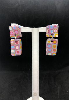 These awesome retro style earrings are lightweight and each pair is completely unique! These funky earrings are made from polymer clay with surgical stainless steel posts. Retro Dangle Earrings For Pierced Ears, Retro Multicolor Drop Earrings, Retro Handmade Drop Earrings, Retro Dangle Jewelry, Handmade Retro Dangle Earrings, Handmade Retro Pink Earrings, Retro Multicolor Jewelry With Matching Earrings, Retro Rectangular Earrings For Gift, Retro Dangle Clip-on Earrings For Gift