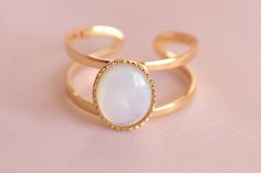 The Alexia ring is a gold-plated ring made up of a double ring and adorned with a natural mother-of-pearl stone. The stone is oval and has a dimension of 1cm x 0.8 cm. Mother-of-pearl is a stone that produces calm, it has a beneficial effect on emotions and promotes the circulation of energy. It is adjustable to fit all fingers. It is possible to buy a matching necklace or ring or bracelet in the store: with the same stone. My jewelry is handmade from materials and fine stones carefully selected Pearl Stone, Double Ring, Plated Ring, Gold Plated Rings, Pink Suede, Multi Stone Ring, Matching Necklaces, Multi Stone, Pearl Ring