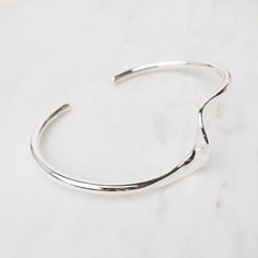 Sterling Silver Cuff with Single Wave The cuff bracelet is an eternal classic and a must-have for every jewelry collection. Stack them, combine plain with texture, mix with stone bracelets, the possibilities are endless. Bright Sterling Silver Approx. 1.9" x 2.5" inner dimensions Handmade in Thailand - Handpicked in Person by our Buyers Modern Sterling Silver Open Cuff Bangle, Modern Sterling Silver Cuff Bracelet Bangle, Minimalist Cuff Bracelet With Oyster Design, Minimalist Metal Cuff Bracelet, Modern Cuff Jewelry For Everyday, Metal Cuff Jewelry For Everyday, Modern Cuff Bracelet With Oyster Design For Gift, Adjustable Polished Open Band Bracelet, Everyday Metal Cuff Jewelry