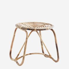 a rattan stool made out of bamboo and wicker with an iron frame on the bottom