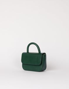 Our ever-popular mini bag, the Nano in a classic autumnal hue: Pine Green, for our FW24 collection. One of the smallest and most compact bags in our collection: The Nano Bag. This itty-bitty bag is all about the essentials. With enough space for your mobile phone, coin purse, lip balm and keys, the little Nano Bag makes a big statement. Featuring an inside zip pocket for extra security and a slip-in pocket for easy access. Her front flap closes with an inner magnet and her strap has a knob-button system to adjust the length. OMB-E137PGV Green Flap Bag With Dust Bag For Daily Use, Small Elegant Bag For Everyday Use, Elegant Small Bag For Everyday Use, Small Bags With Detachable Handle For Everyday Use, Small Bag With Detachable Handle For Everyday Use, Small Bag With Detachable Strap, Classic Green Satchel For On-the-go, Small Everyday Bag With Detachable Handle, Small Elegant Bag With Detachable Strap