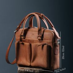 a brown leather briefcase is shown with measurements for the handles and shoulder straps on it