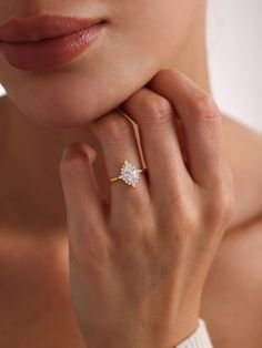 a woman's hand with a diamond ring on her finger