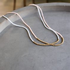 Our lithe necklace is handcrafted with a touch of gold in a minimalist style. •Seed beads hand strung in a minimalist pattern •Choose between blush or light blue •14kt Gold-Filled accents •16 inches in length or 16 inches with a 2 inch extender Everyday 14k Gold-filled Necklaces With Tiny Beads, Everyday 14k Gold Filled Tiny Beads Necklace, Everyday 14k Gold-filled Necklace With Tiny Beads, Everyday 14k Gold Filled Necklace With Tiny Beads, Everyday Beaded 14k Gold-filled Necklaces, Everyday Beaded 14k Gold-filled Necklace, Everyday Beaded 14k Gold Filled Necklace, Everyday 14k Gold Filled Beaded Necklace, Adjustable Rose Gold Beaded Necklace