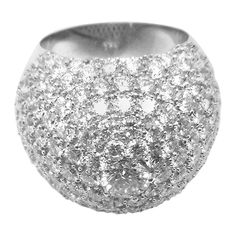 a large silver ring with lots of small white diamonds in it's center, on a white background