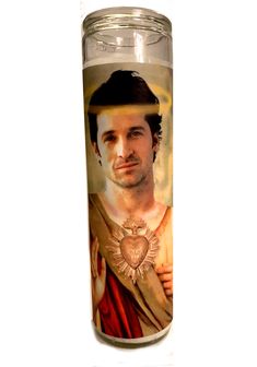 a candle with the likeness of jesus painted on it's front and back sides