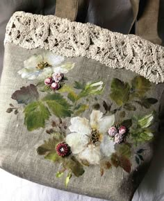 an old purse with flowers and lace on it