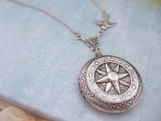 . Vintage Round Compass Jewelry, Vintage Round Compass Pendant Jewelry, Vintage Silver Jewelry With Compass Design, Vintage Compass Design Round Pendant Jewelry, Antique Silver Jewelry With Compass Design, Antique Compass Medallion Jewelry, Vintage Silver Compass Design Jewelry, Antique Silver Round Locket Necklace With Vintage Charm, Antique Medallion With Compass Design Jewelry