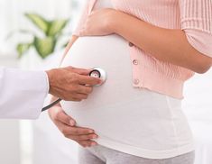 a pregnant woman being examined by a doctor