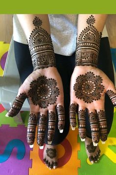 two hands with henna designs on them